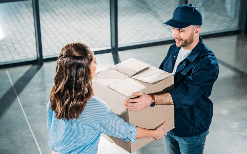 courier-and-woman-holding-cardboard-box.jpg